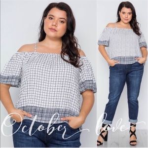 Cute strappy off the shoulder plus sized shirt. It is blue and white.